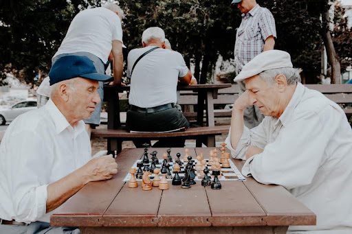 senior men playing chess