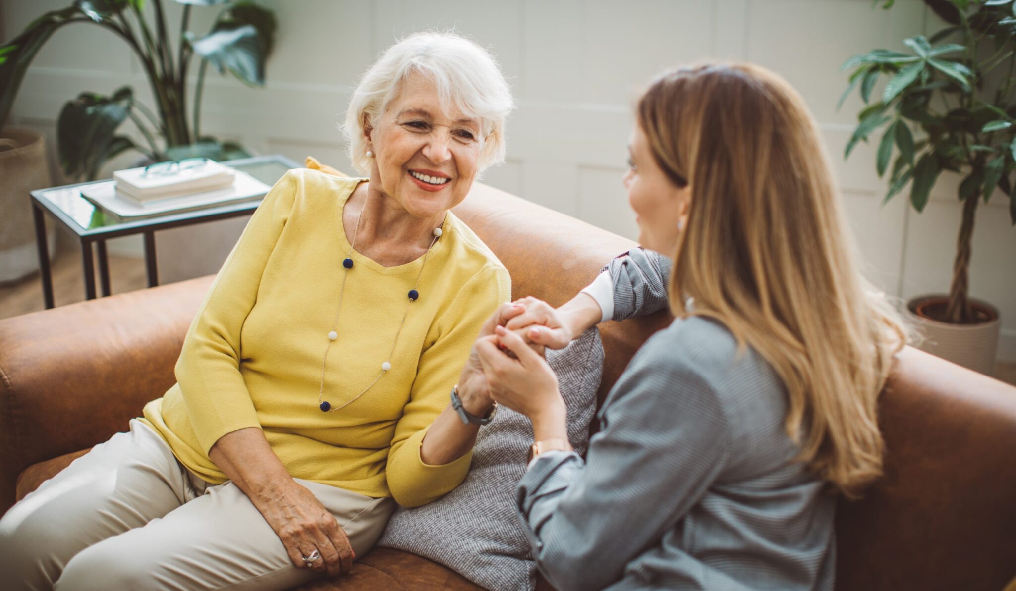 Manging parents finances Senior woman talking with her daughter at home 